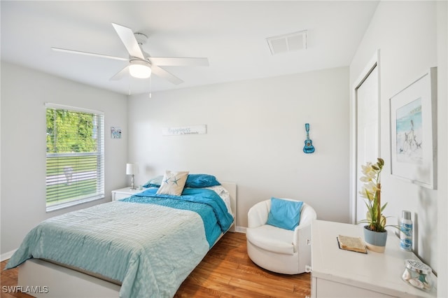 bedroom featuring ceiling fan, hardwood / wood-style flooring, and a closet