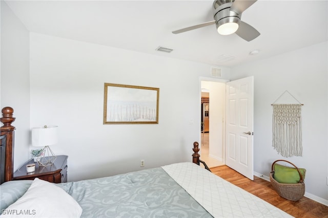 bedroom with light wood-type flooring and ceiling fan