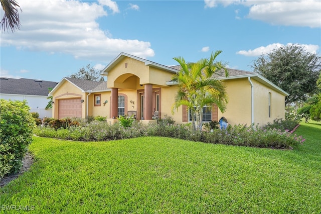 view of front of property featuring a front yard and a garage