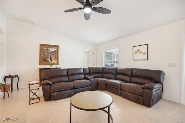 living room featuring ceiling fan, lofted ceiling, and light tile patterned floors