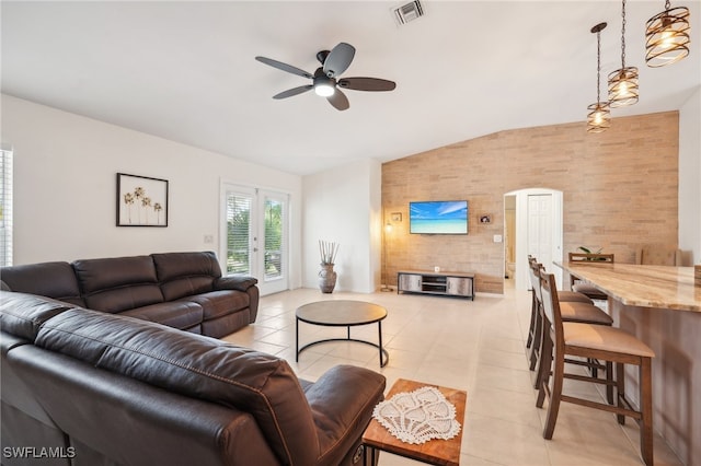 living room with light tile patterned floors, vaulted ceiling, and ceiling fan