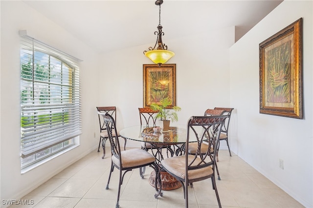 tiled dining area with vaulted ceiling