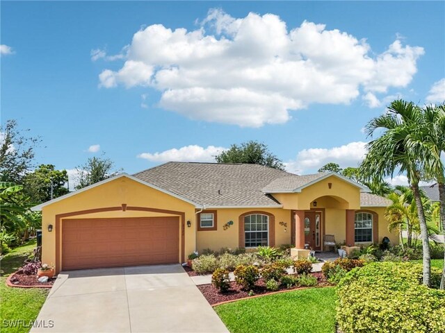 view of front of property featuring a garage and a front lawn