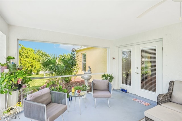 sunroom / solarium with ceiling fan, french doors, and a wealth of natural light