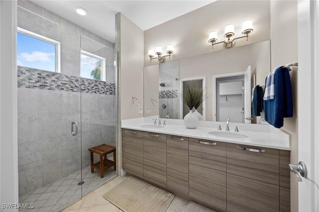 14151 Nautica Ct, Naples, FL 34114 - bathroom with double vanity, a stall shower, and a sink