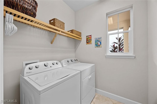 14151 Nautica Ct, Naples, FL 34114 - laundry room with light tile patterned floors, laundry area, separate washer and dryer, and baseboards