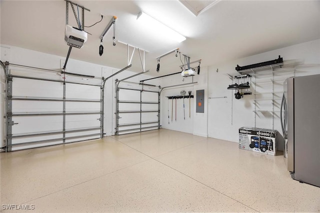 14151 Nautica Ct, Naples, FL 34114 - garage with a garage door opener, freestanding refrigerator, and electric panel