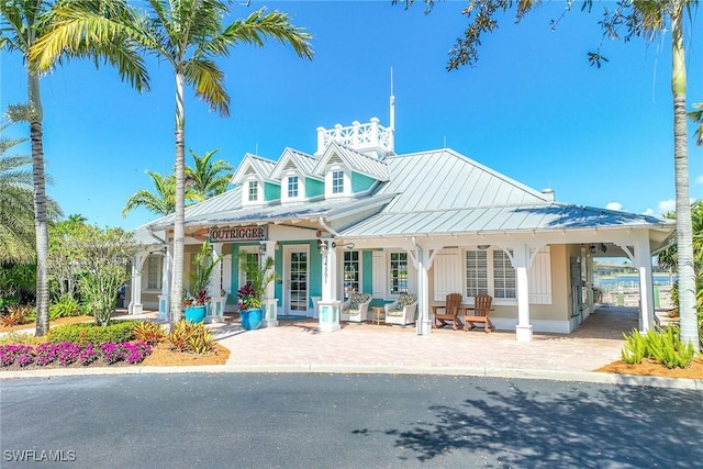 14151 Nautica Ct, Naples, FL 34114 - exterior space with a carport, a standing seam roof, metal roof, and covered porch