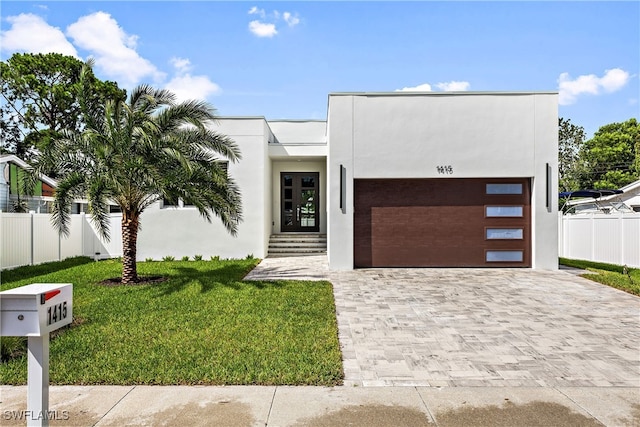 view of front facade with a garage and a front yard