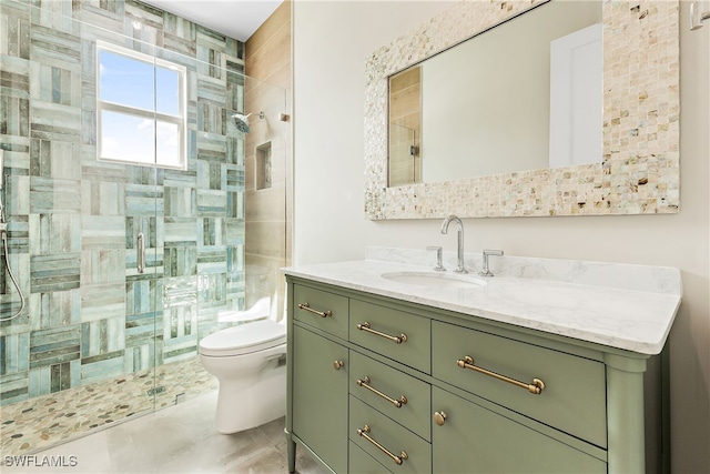 bathroom featuring vanity, toilet, and walk in shower