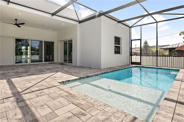 view of pool featuring ceiling fan, a lanai, and a patio area