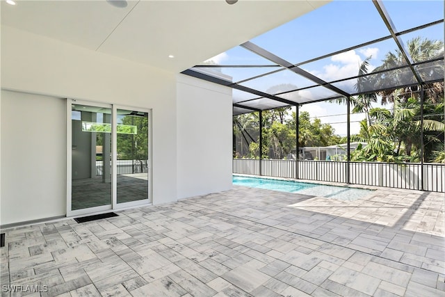 exterior space with glass enclosure and a patio