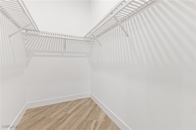 walk in closet featuring hardwood / wood-style flooring