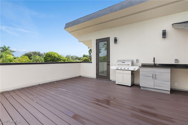 wooden deck with sink and grilling area