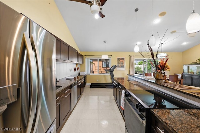 kitchen with pendant lighting, dark brown cabinets, lofted ceiling, and appliances with stainless steel finishes