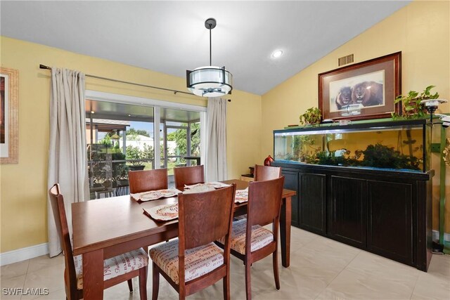 dining room featuring lofted ceiling