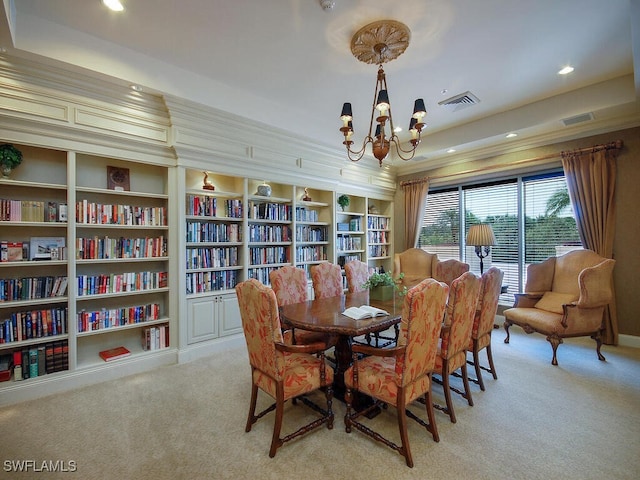 carpeted dining area with built in shelves, a notable chandelier, and ornamental molding