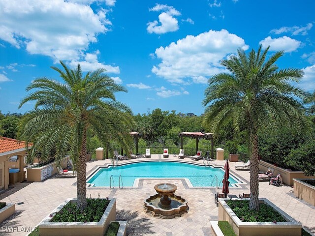 pool with a patio and fence