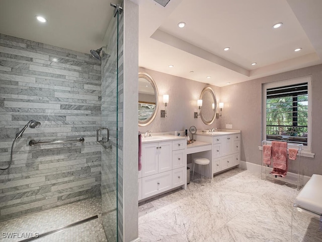 bathroom featuring an enclosed shower, a raised ceiling, and vanity