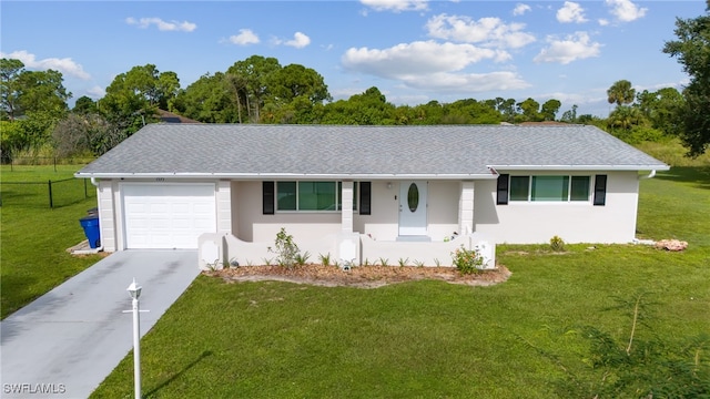 single story home with a garage and a front lawn