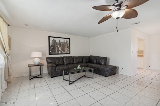 tiled living room featuring ceiling fan