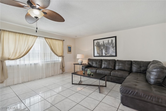 tiled living room featuring a textured ceiling and ceiling fan