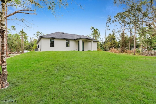 rear view of house with a lawn