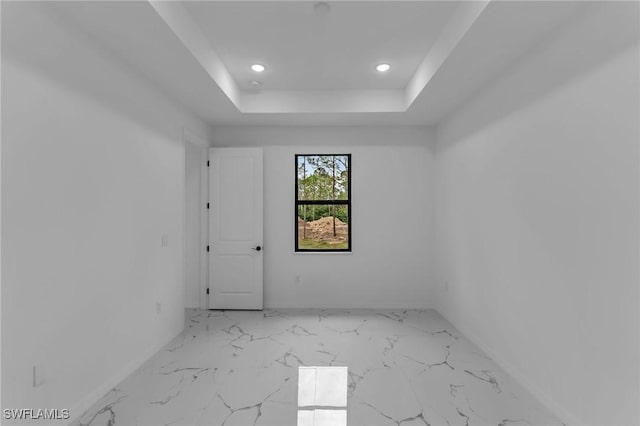 spare room featuring a tray ceiling