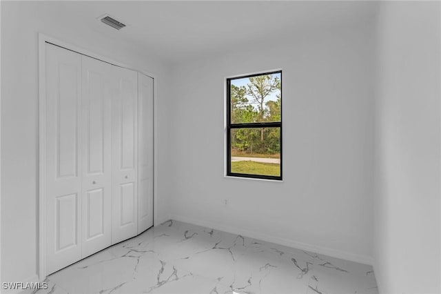 unfurnished bedroom with a closet