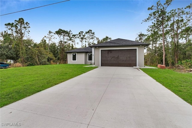 view of front of home featuring a front yard and a garage