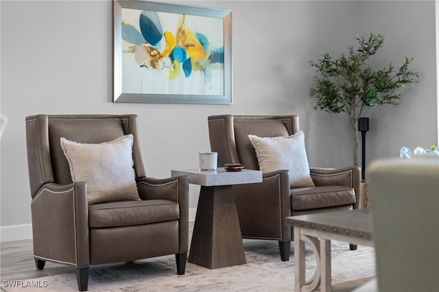 sitting room featuring baseboards and wood finished floors