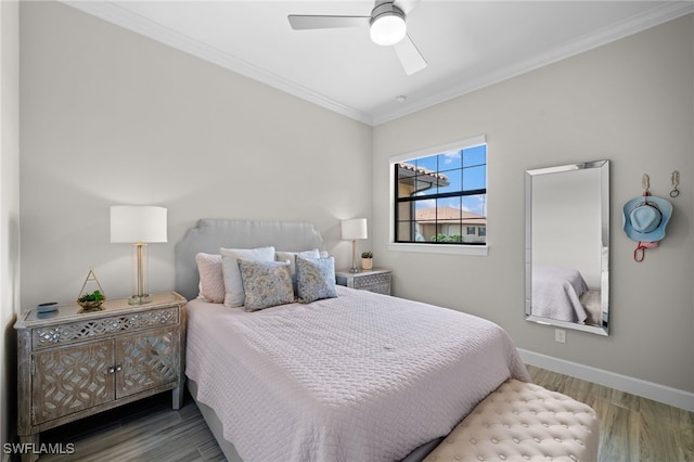 bedroom featuring baseboards, ceiling fan, wood finished floors, and crown molding