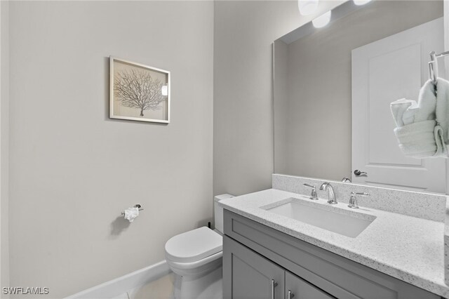 bathroom with tile patterned floors, vanity, and toilet