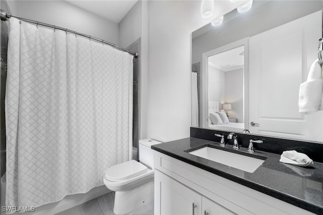 bathroom with shower / tub combo, vanity, and toilet