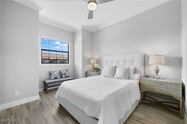 bedroom with light wood-type flooring, ceiling fan, and ornamental molding