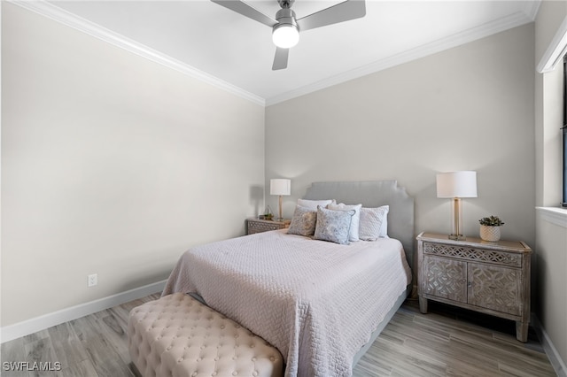 bedroom with baseboards, ornamental molding, and wood finished floors