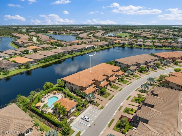 birds eye view of property featuring a water view and a residential view