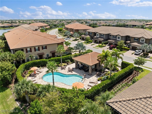 pool with a residential view, a patio, and a gazebo