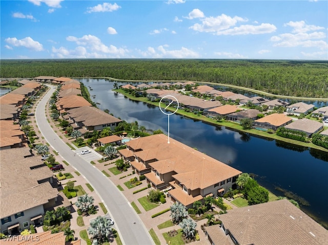 birds eye view of property with a residential view, a water view, and a forest view