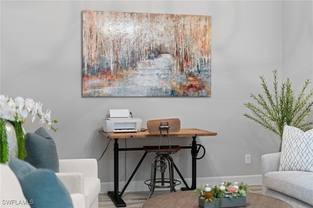 office area with baseboards and wood finished floors