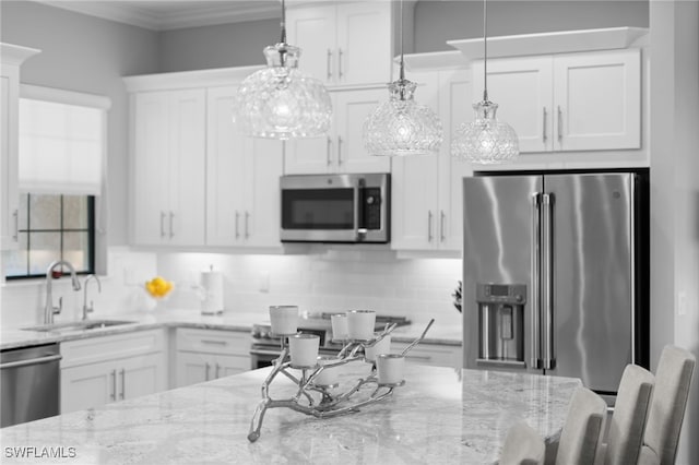 kitchen featuring tasteful backsplash, white cabinetry, stainless steel appliances, and a sink