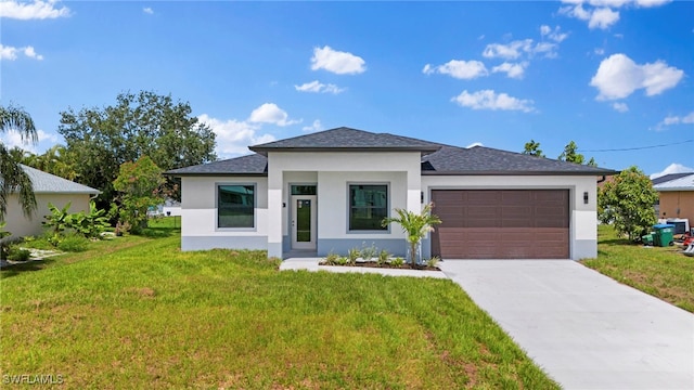 prairie-style house featuring a garage and a front lawn