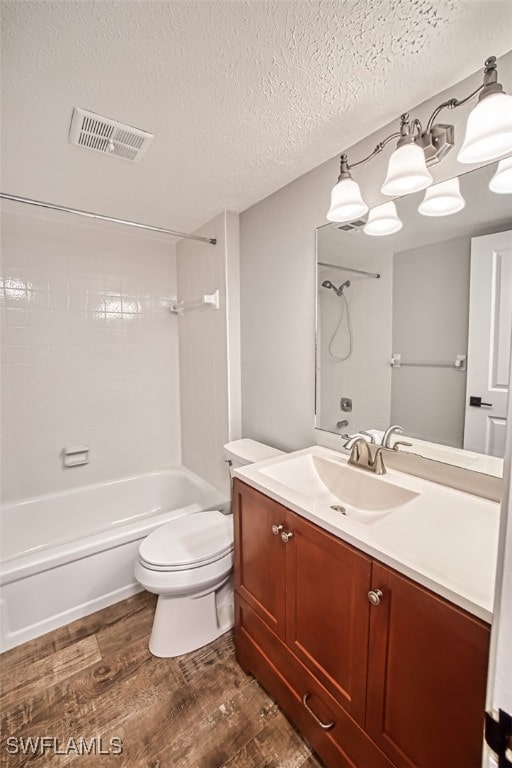 4835 Bonita Beach Rd Unit 408, Bonita Springs, FL 34134 - full bath featuring visible vents, toilet, wood finished floors, tub / shower combination, and a textured ceiling