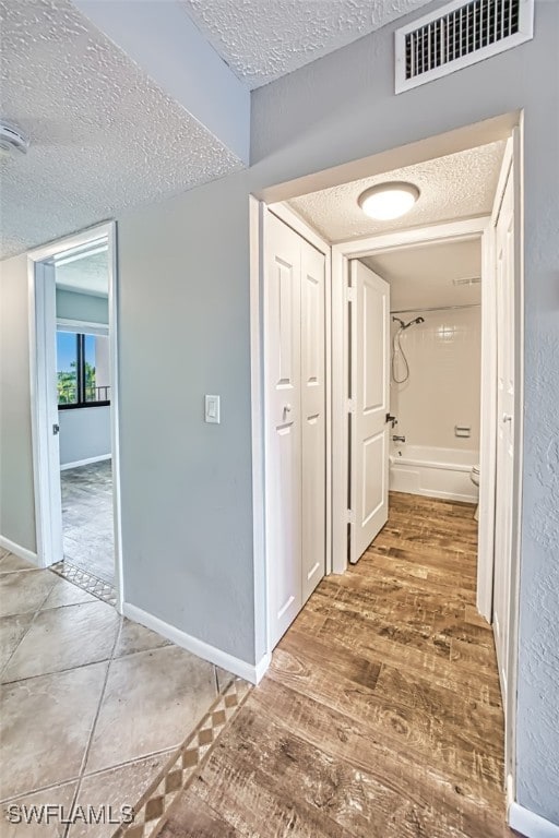 4835 Bonita Beach Rd Unit 408, Bonita Springs, FL 34134 - hall featuring a textured ceiling, wood finished floors, visible vents, and baseboards