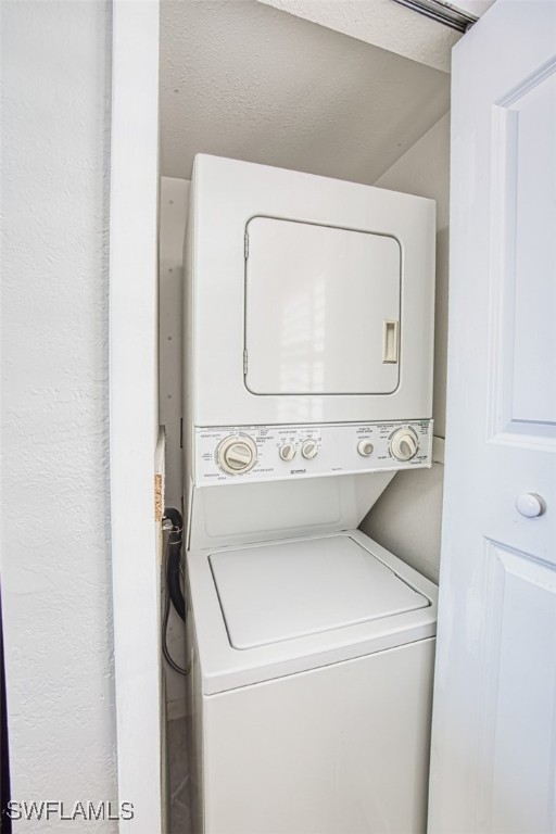 laundry area featuring stacked washer and clothes dryer