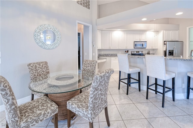 dining space featuring light tile patterned floors