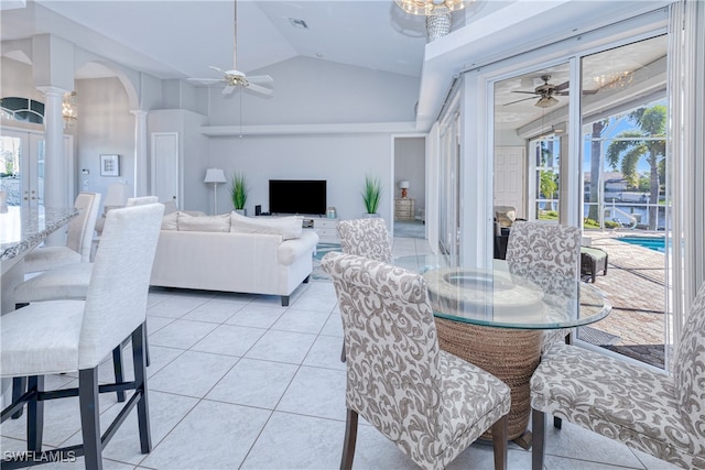 tiled dining room featuring lofted ceiling, a healthy amount of sunlight, ceiling fan, and decorative columns