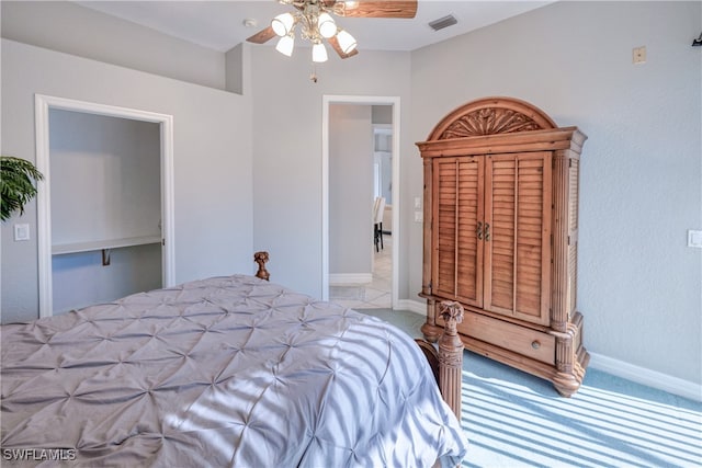 bedroom featuring light colored carpet and ceiling fan