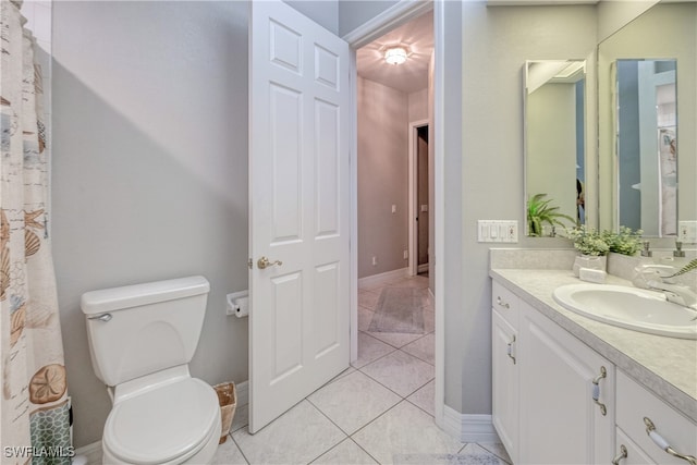 bathroom with vanity, toilet, and tile patterned floors