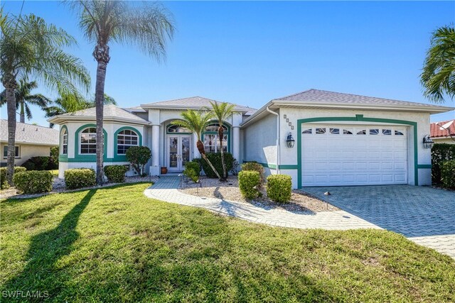 view of front of home featuring a garage and a front yard